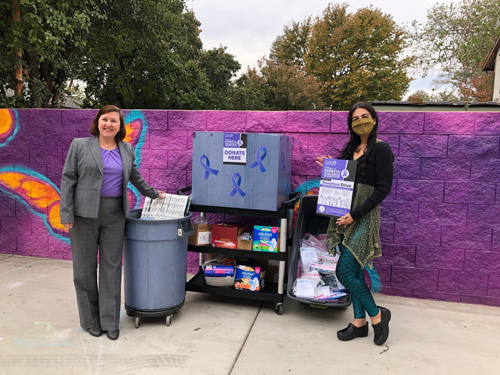 Lynda Gledhill and Jessica Mougharbel standing in front of the donations collected.