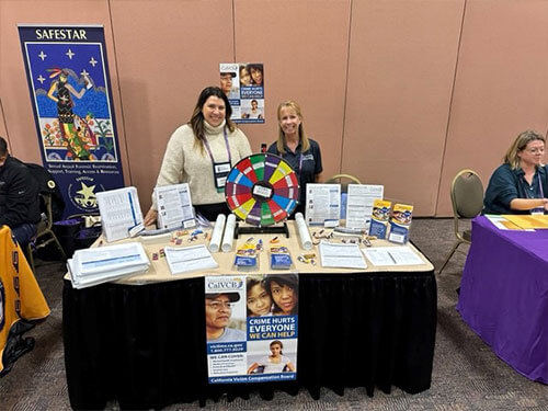 Two women standing behind a table event