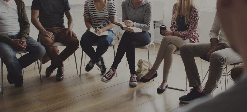 Group of people sitting in a chairs.